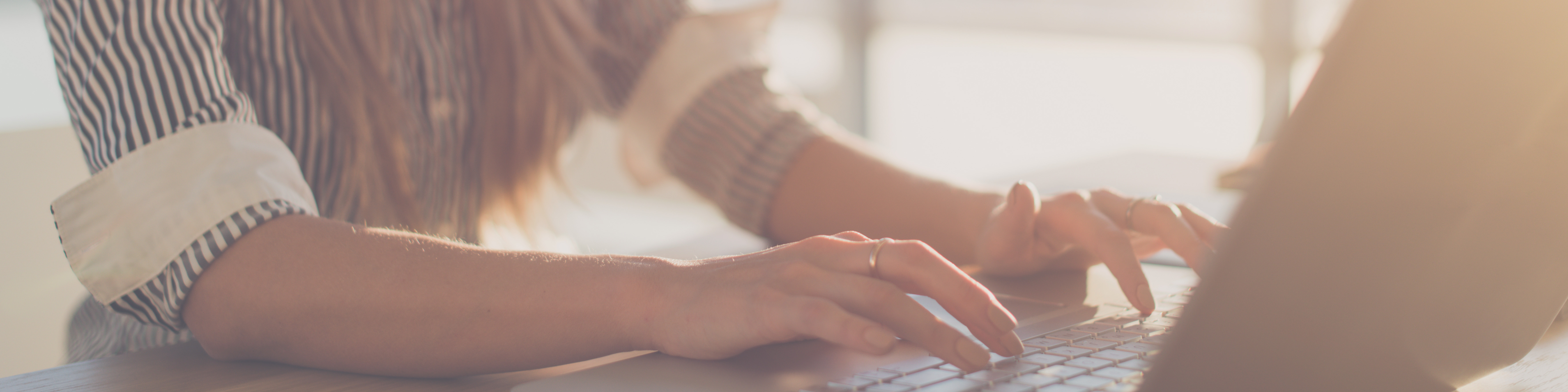 woman typing on laptop writing Financial Advisor Blog vermont
